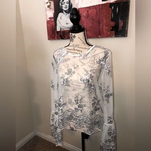 Never worn, excellent condition sheer white blouse with silver sequin accents.